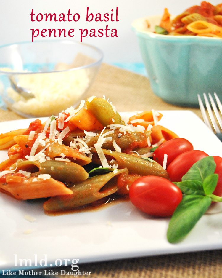 tomato basil penne pasta Front view of tomato basil penne pasta on a white plate.
