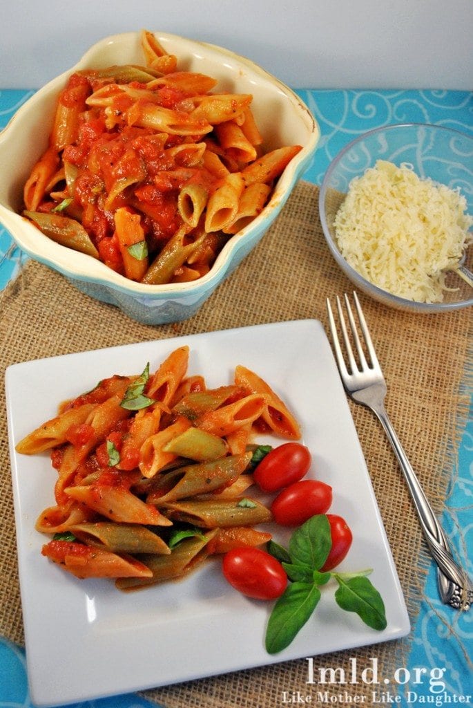 tomato basil penne pasta Top view of tomato basil penne pasta on a white plate.