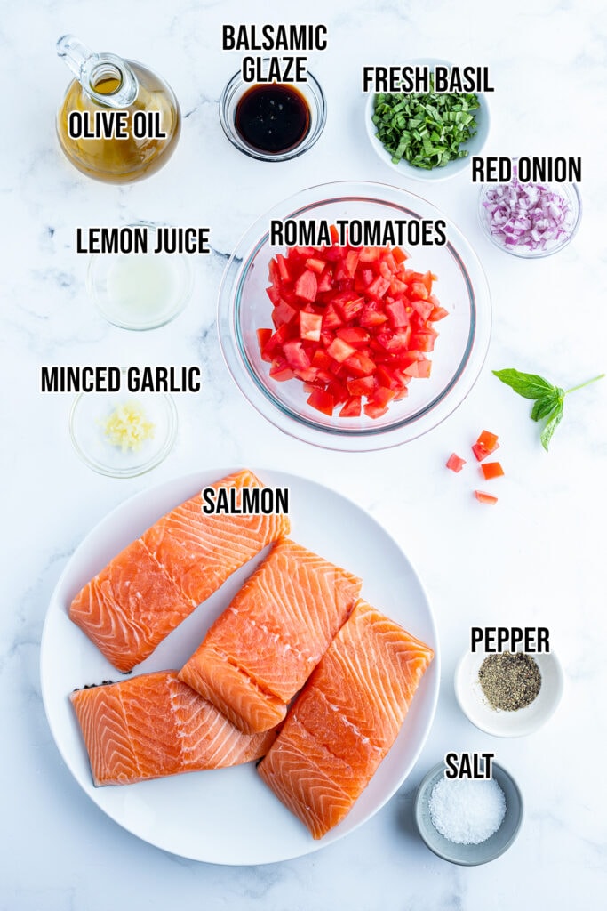 A top view of the ingredients needed to make tomato basil salmon. 
