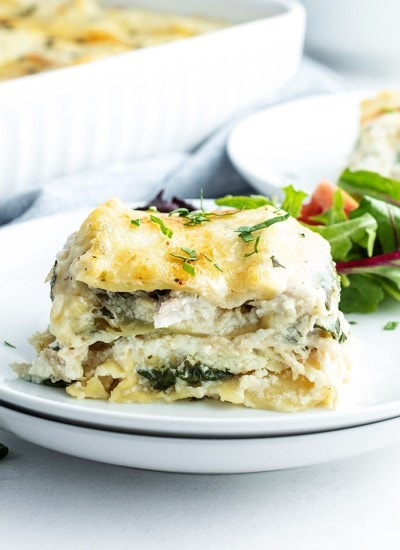 Chicken lasagna with spinach on a plate.
