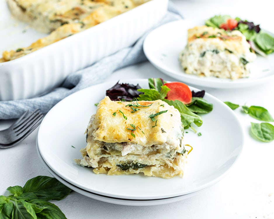Chicken lasagna with spinach on a plate.