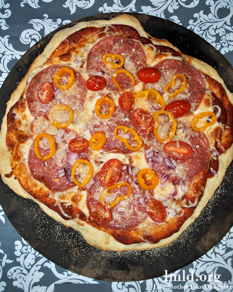 Top view of an Italian pizza cooking in a pan.