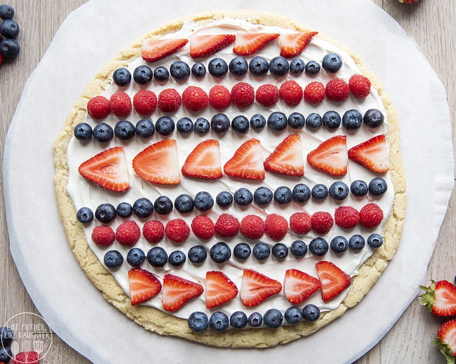 Red White and Blue Fruit Pizza with blueberries, strawberries, and raspberries on top.