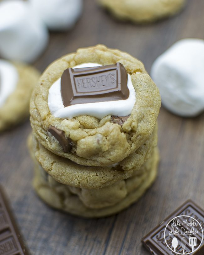 Close up view of a smores cookie on a wood board.