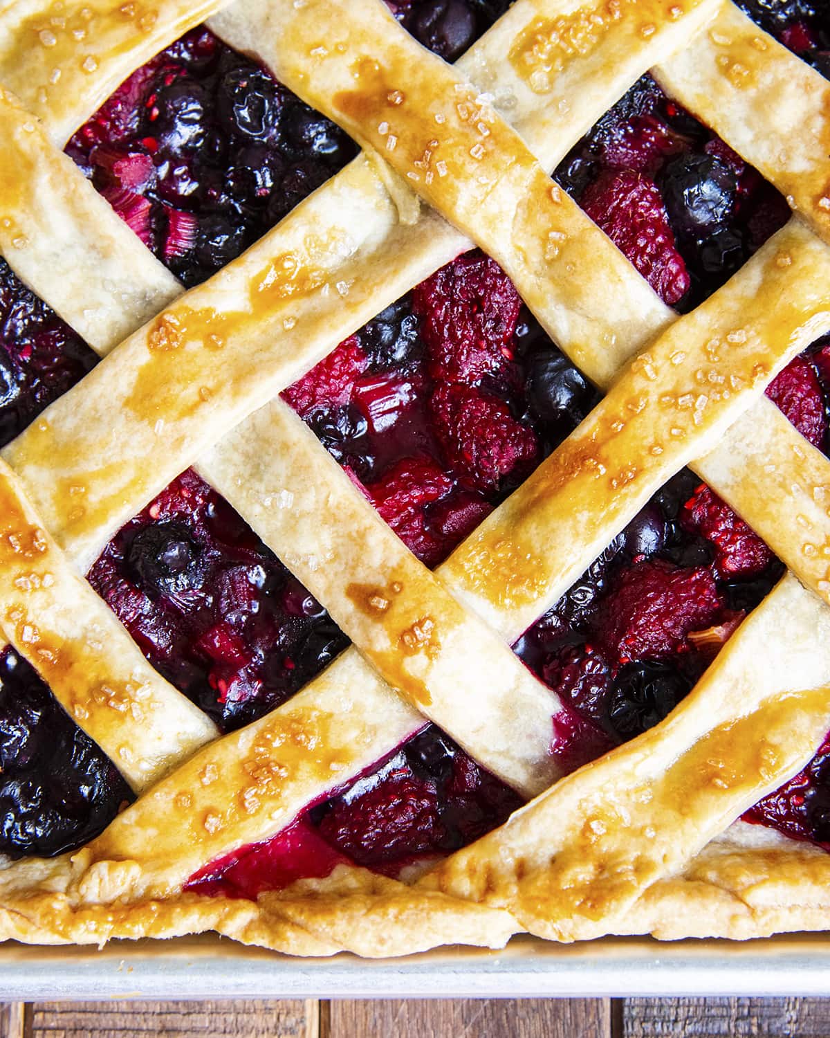 A close up of a lattice topped berry pie.