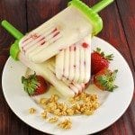 Angled view of strawberry granola yogurt pops on a plate.