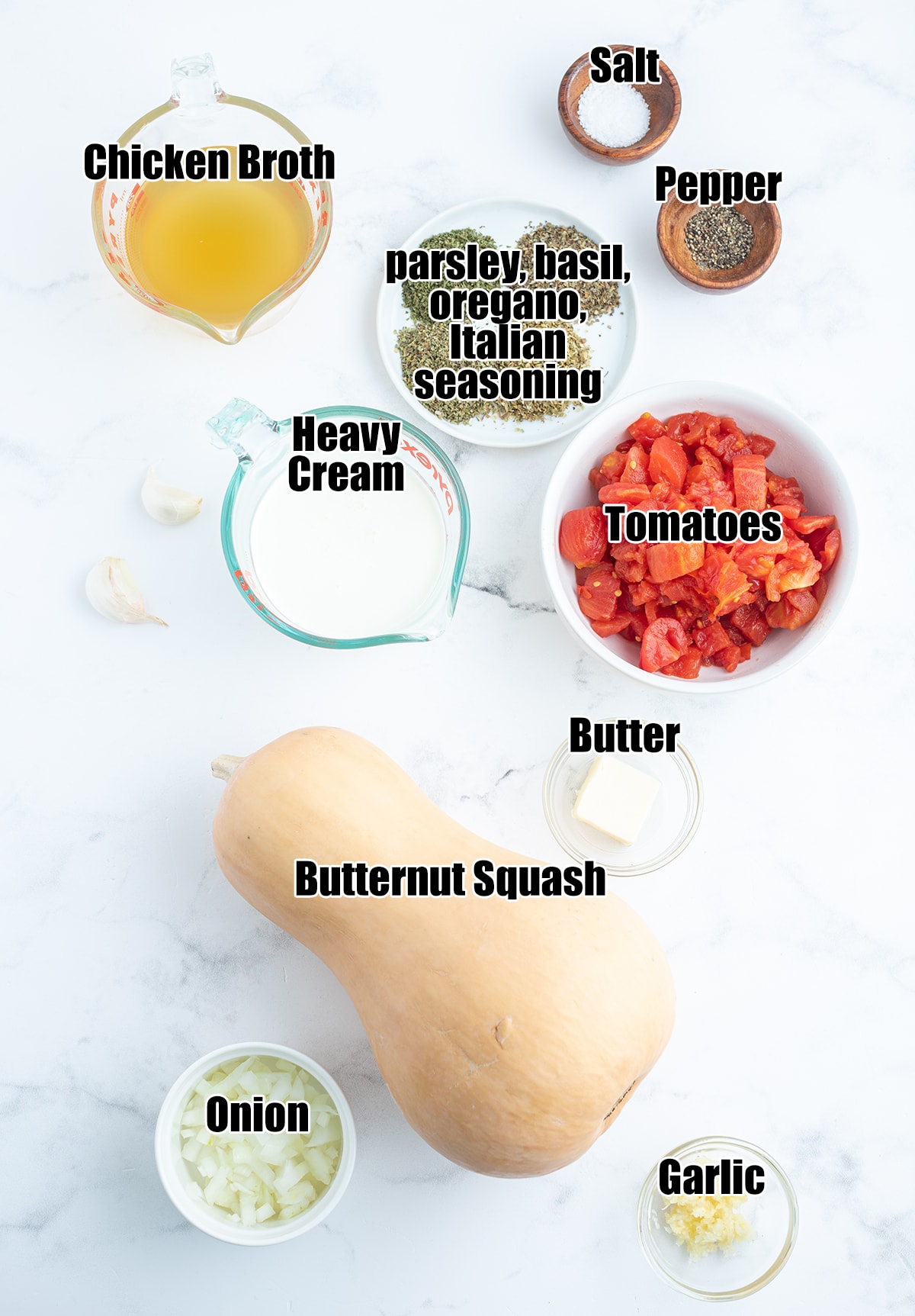 An overhead photo of the ingredients needed to make tomato squash soup, with labels on them.