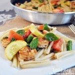 Angled view of pasta primavera on a white plate.
