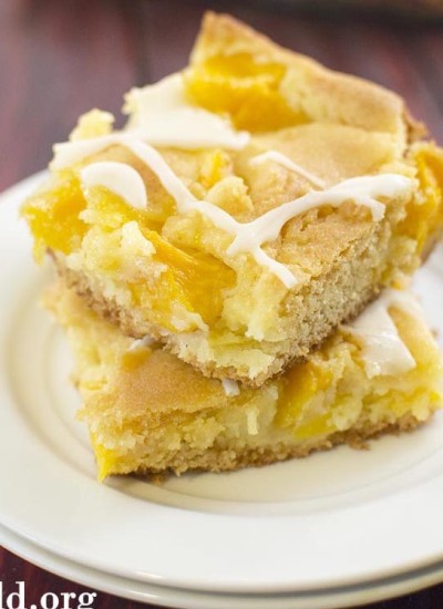 Angled view of peach cobbler bars on a white plate.