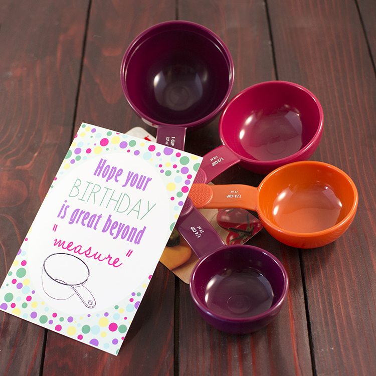 Angled view of measuring cups with a birthday card on the front.