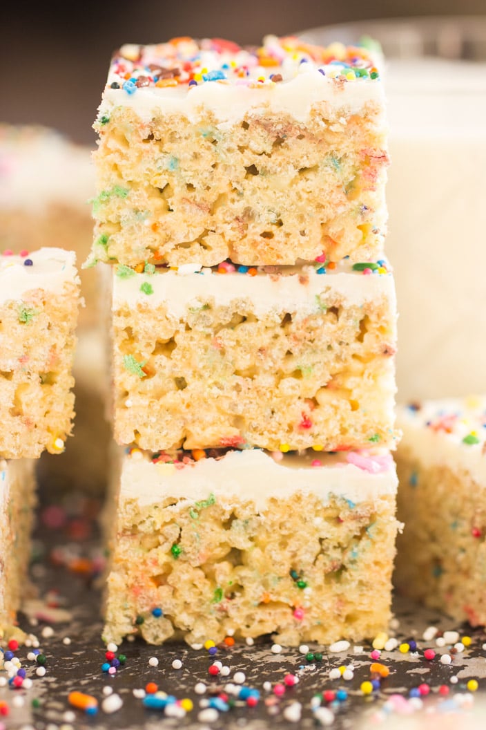 A side image of funfetti birthday cake rice krispie treats staked on top of each other.