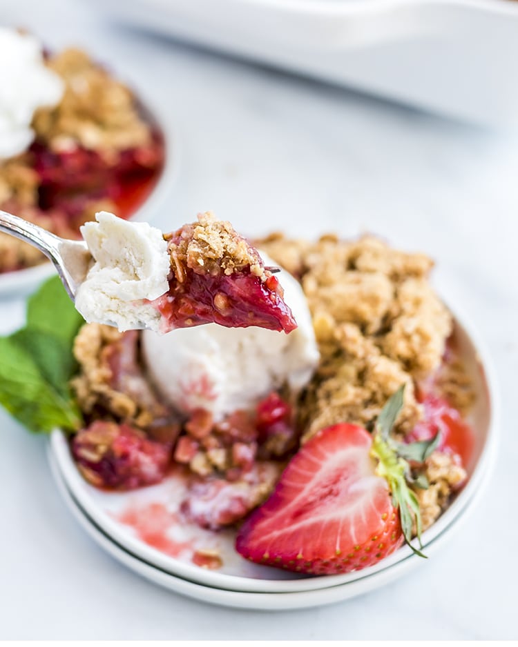 A bite of strawberry rhubarb crumble on a fork