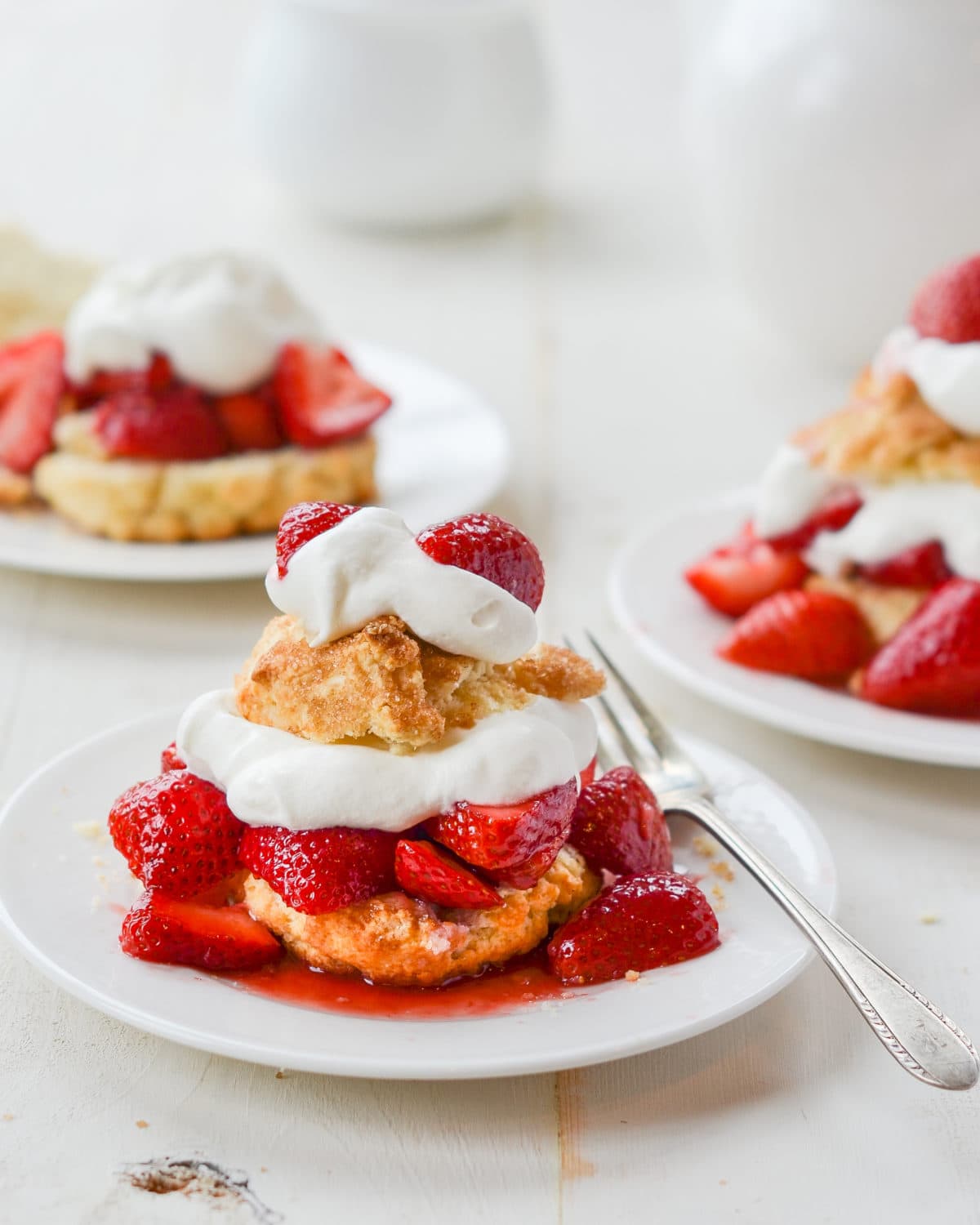 Strawberry Shortcake layered with biscuit, strawberries, and cream on a plate