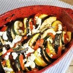 Top view of ratatouille in a red baking pan.
