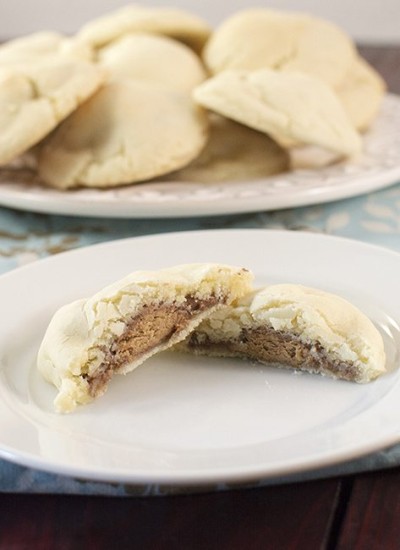 Front view of candy bar surprise cookies on a white plate.