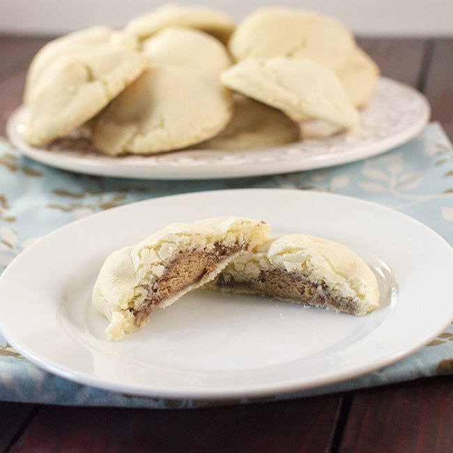 Front view of candy bar surprise cookies on a white plate.