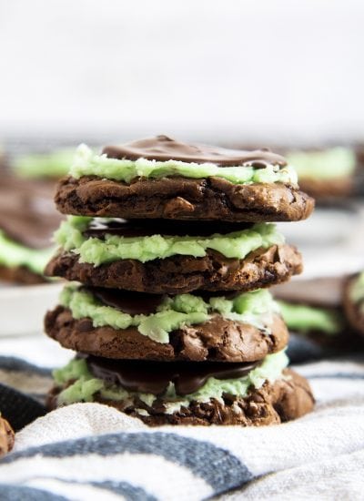 A stack of mint brownie cookies, with a mint buttercream, and chocolate topping.