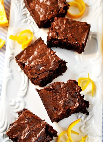 Top view of orange brownies on a white plate.