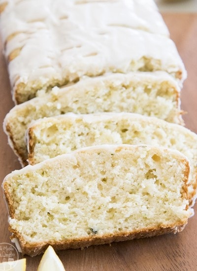 Slices of lemon zucchini bread with glaze on top.