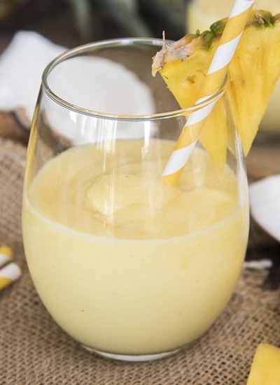 Front view of a pina colada smoothie inside of a glass.
