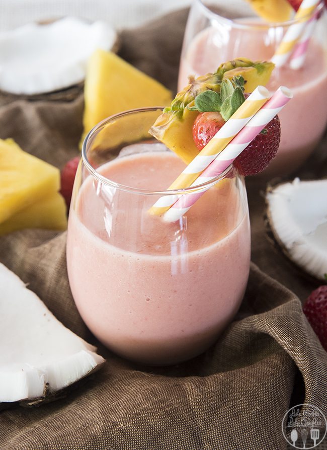 Front view of a strawberry pina colada smoothie in a glass.