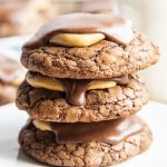 A square close up photo of a stack of three buckeye brownie cookies.