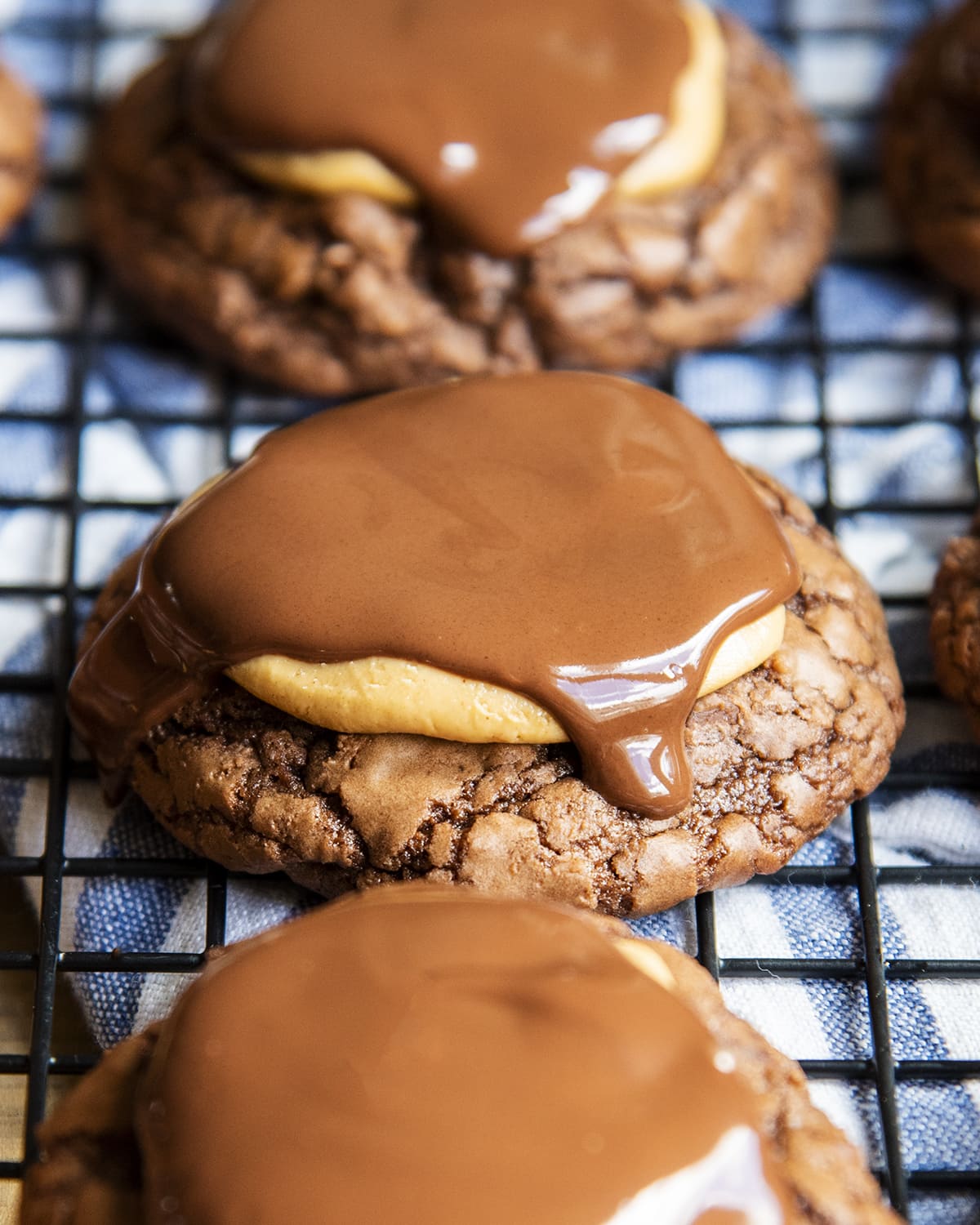 A close up of a buckeye brownie cookies topped with peanut butter and melted chocolate. 