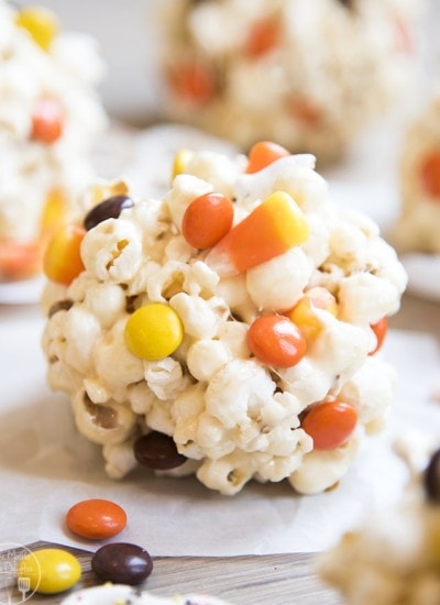 A Halloween popcorn ball on waxed paper.
