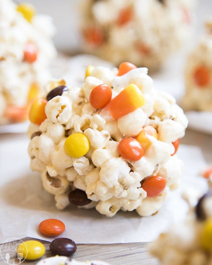 A Halloween popcorn ball on waxed paper. 