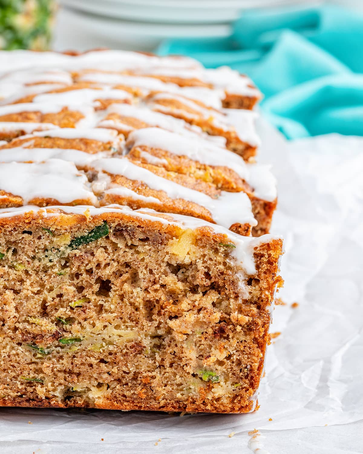 A close up of a loaf of sliced pineapple zucchini bread.