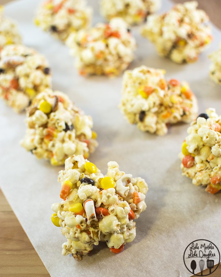Angled view of halloween popcorn on parchment paper.