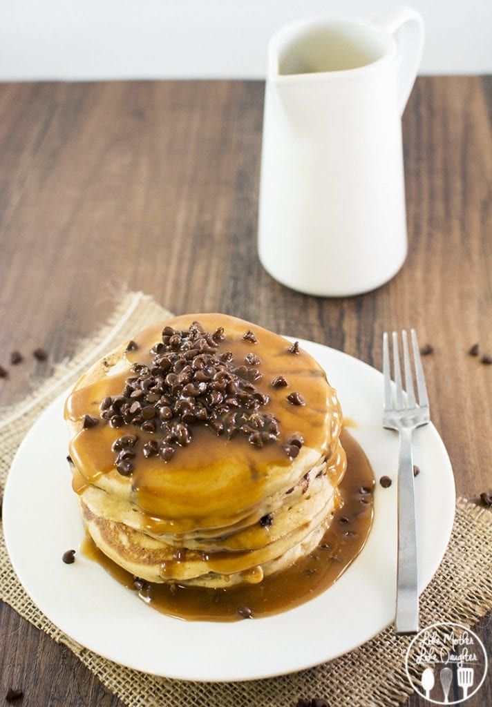 Top view of peanut butter chocolate chip pancakes with syrup on top.