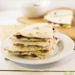 Stacked pieces of quesadillas full of bacon and avocado.