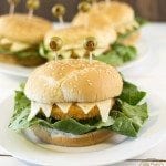 Front view of chicken sandwich monsters on white plates.