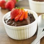 Front view of chocolate avocado pudding in a white ramekin.