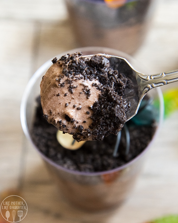 Dirt Pudding Cups with chocolate pudding topped with crushed chocolate cookies and candy worms