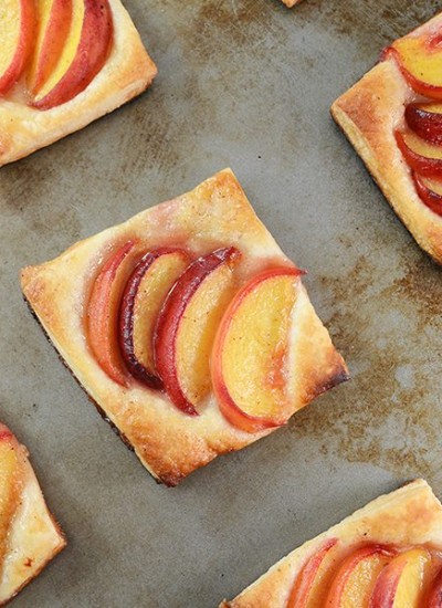 Top view of peach tart on a baking pan.