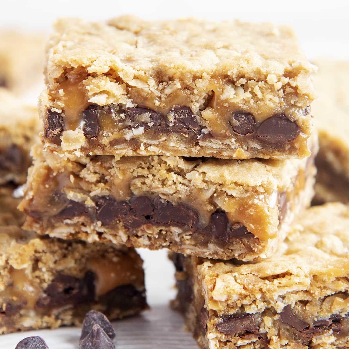 A square photo of two carmelitas bars stacked on top of each other, showing the chocolate and caramel in the middle.