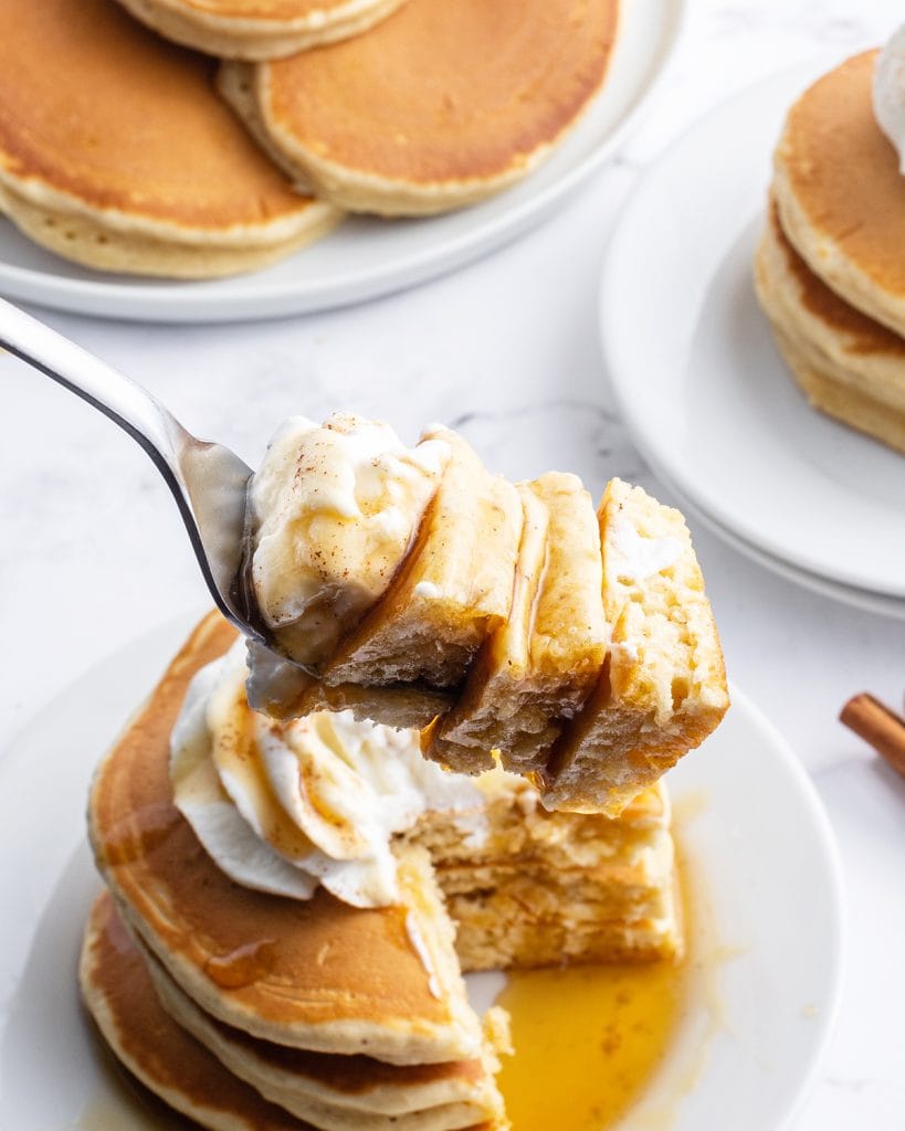 Bites of eggnog pancakes on a fork.