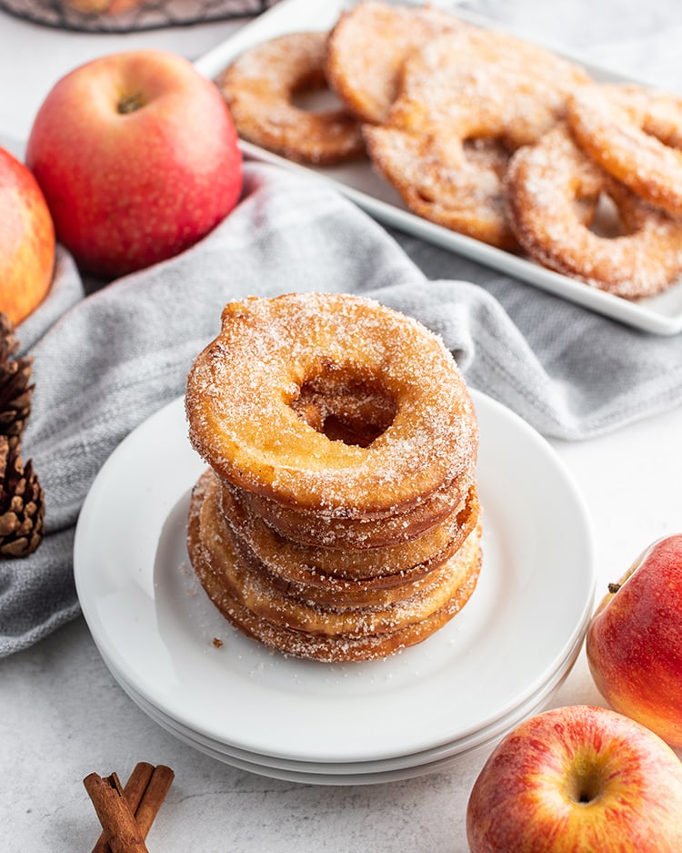 A stack of fried apple rings on a plate.