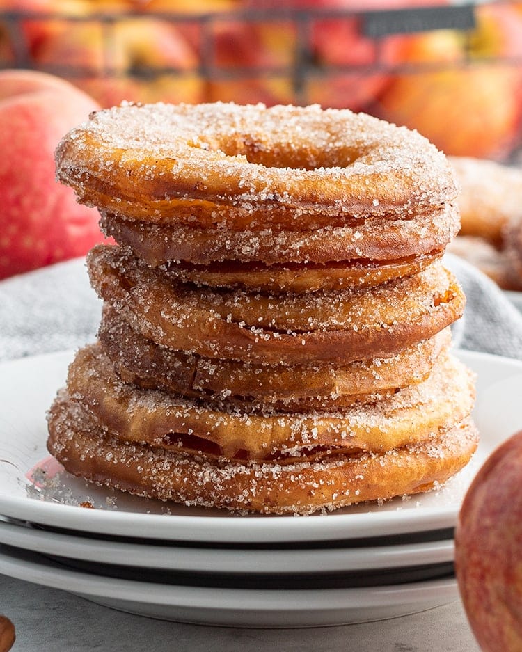A stack of fried apple rings on a plate.