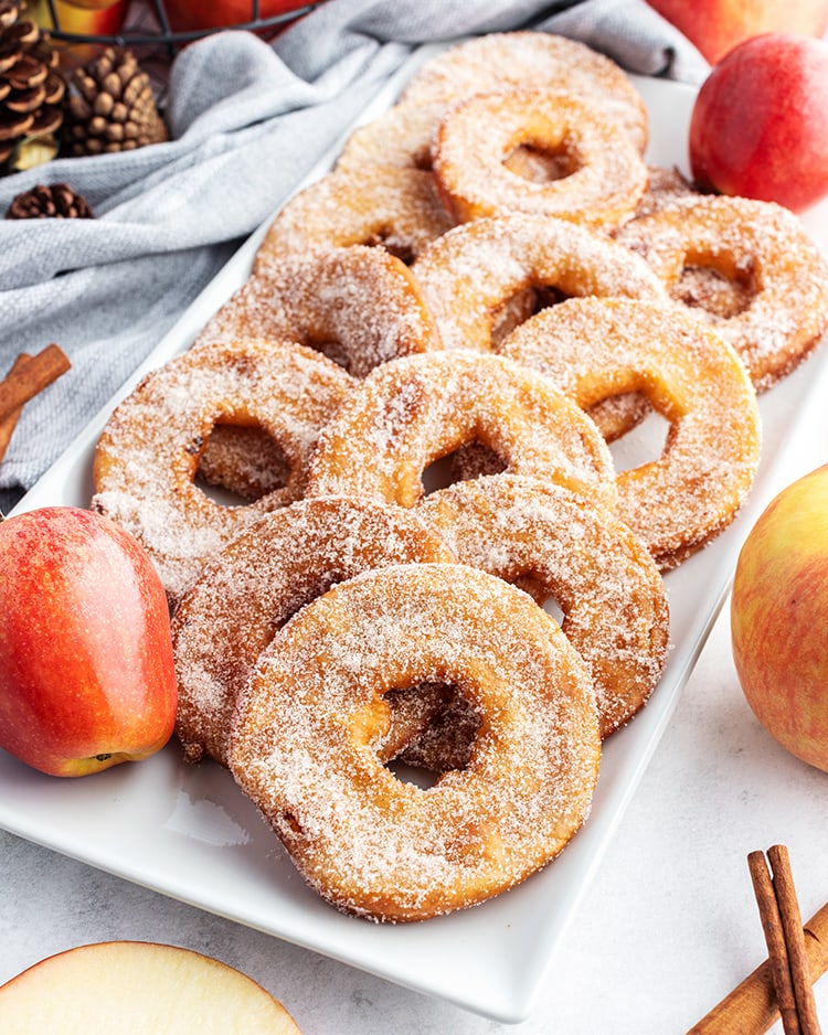 A plate of fried apple rings coated in cinnamon sugar.
