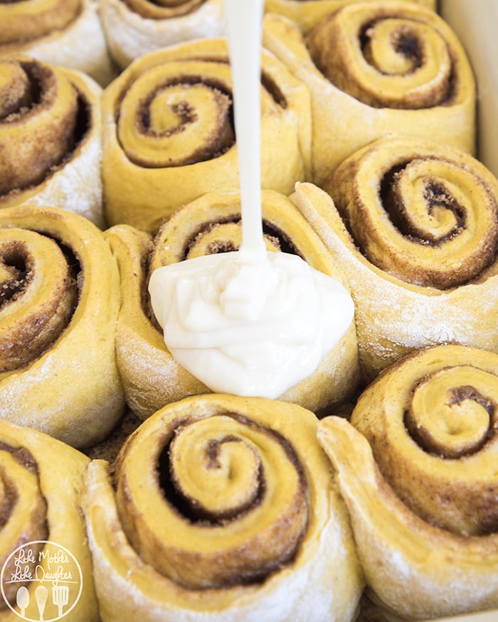Pumpkin Cinnamon Rolls topped with a tangy cream cheese frosting