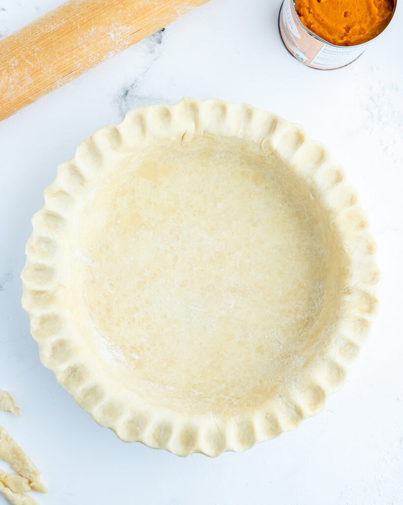 An above view of an unbaked pie crust.