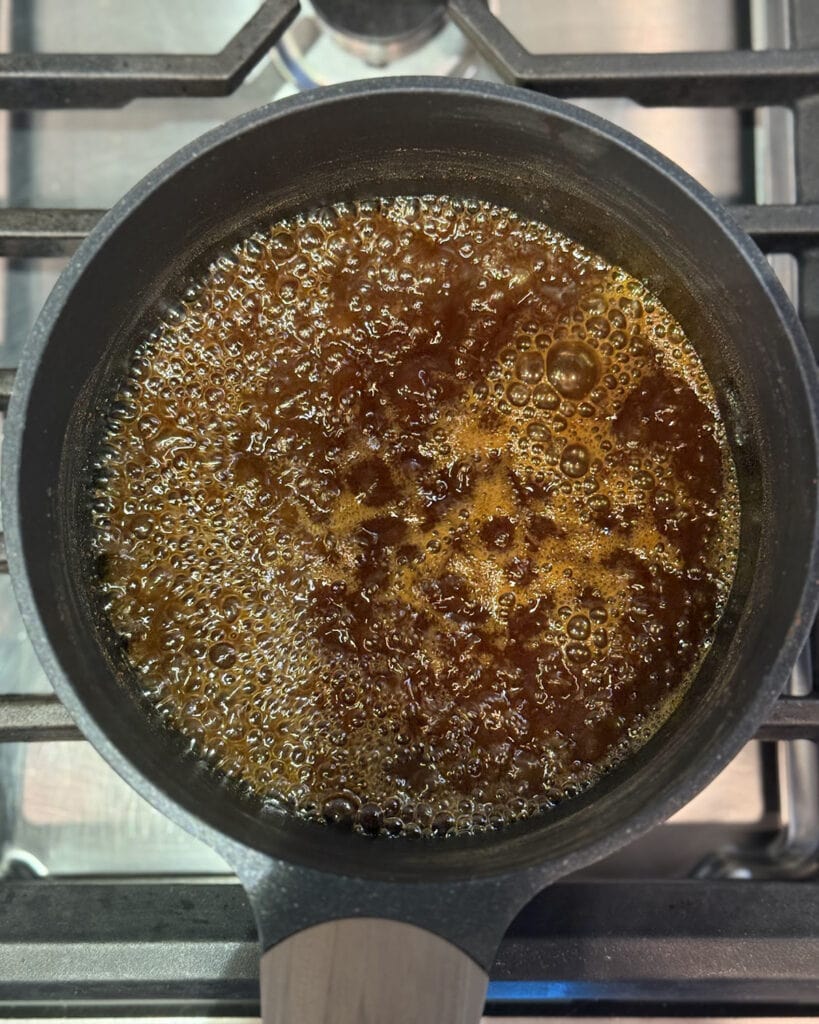 Boiling pumpkin syrup in a pan.