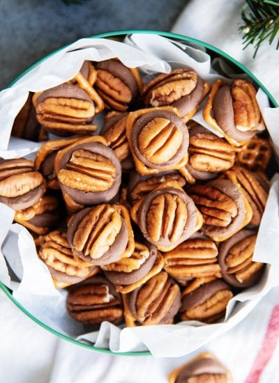 A metal tin full of a pile of rolo pretzel turtles.