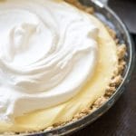 Close up view of banana cream pie in a glass pie pan.