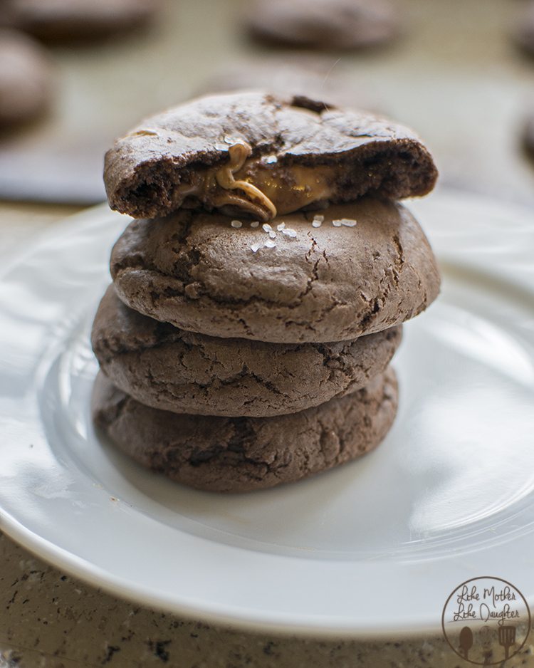 A stack of chocolate cake mix cookies with rolos in the middle.