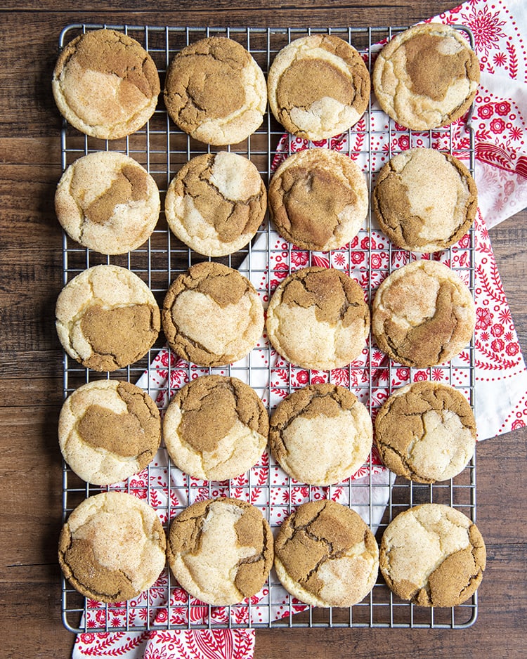 A cooling rack with gingerdoodle cookies set across 4x5. The cookies are half ginger molasses, half snickerdoodle cookie swirled together.