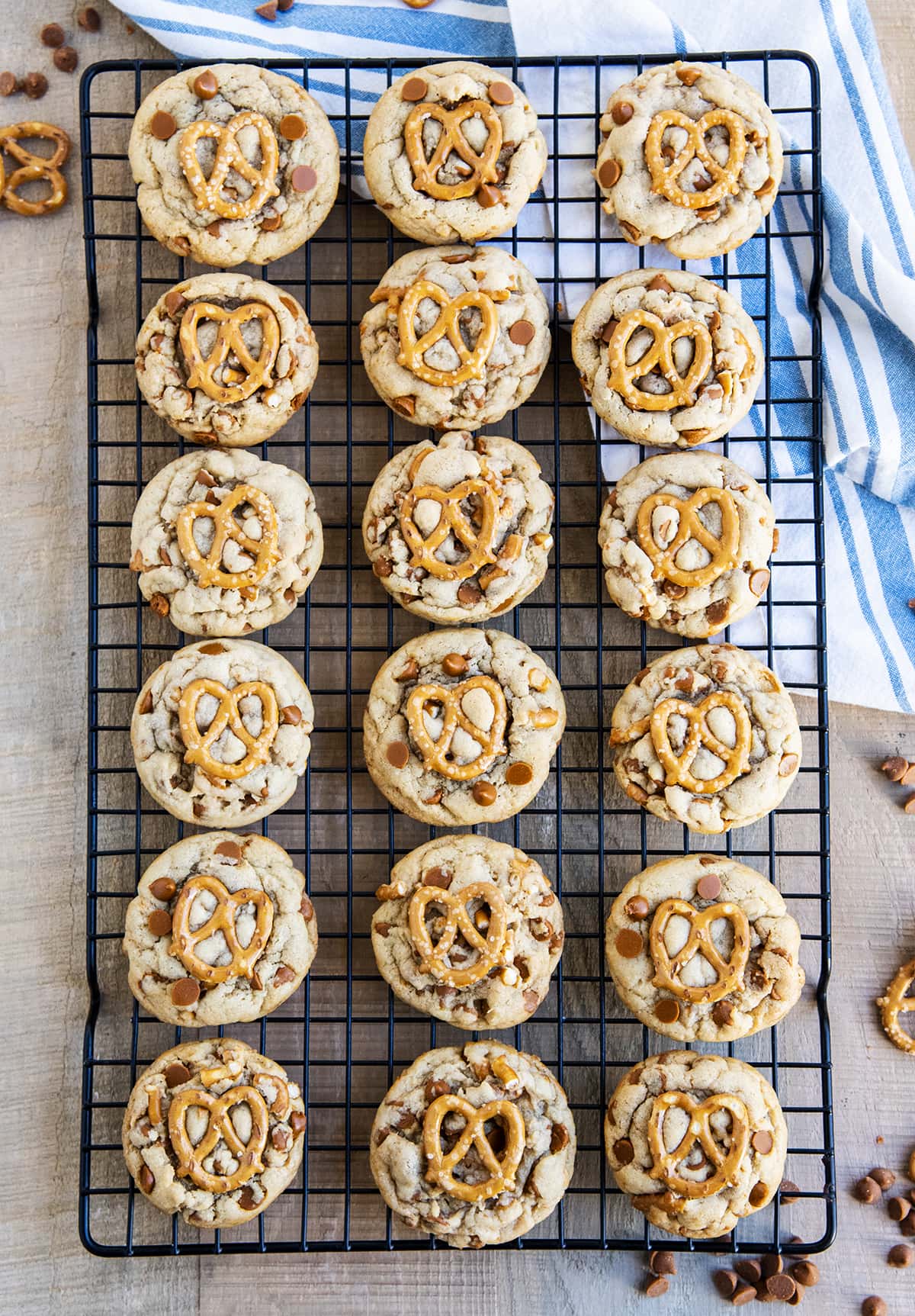 An overhead photo of pretzel cinnamon chip cookies on a black cooling rack.